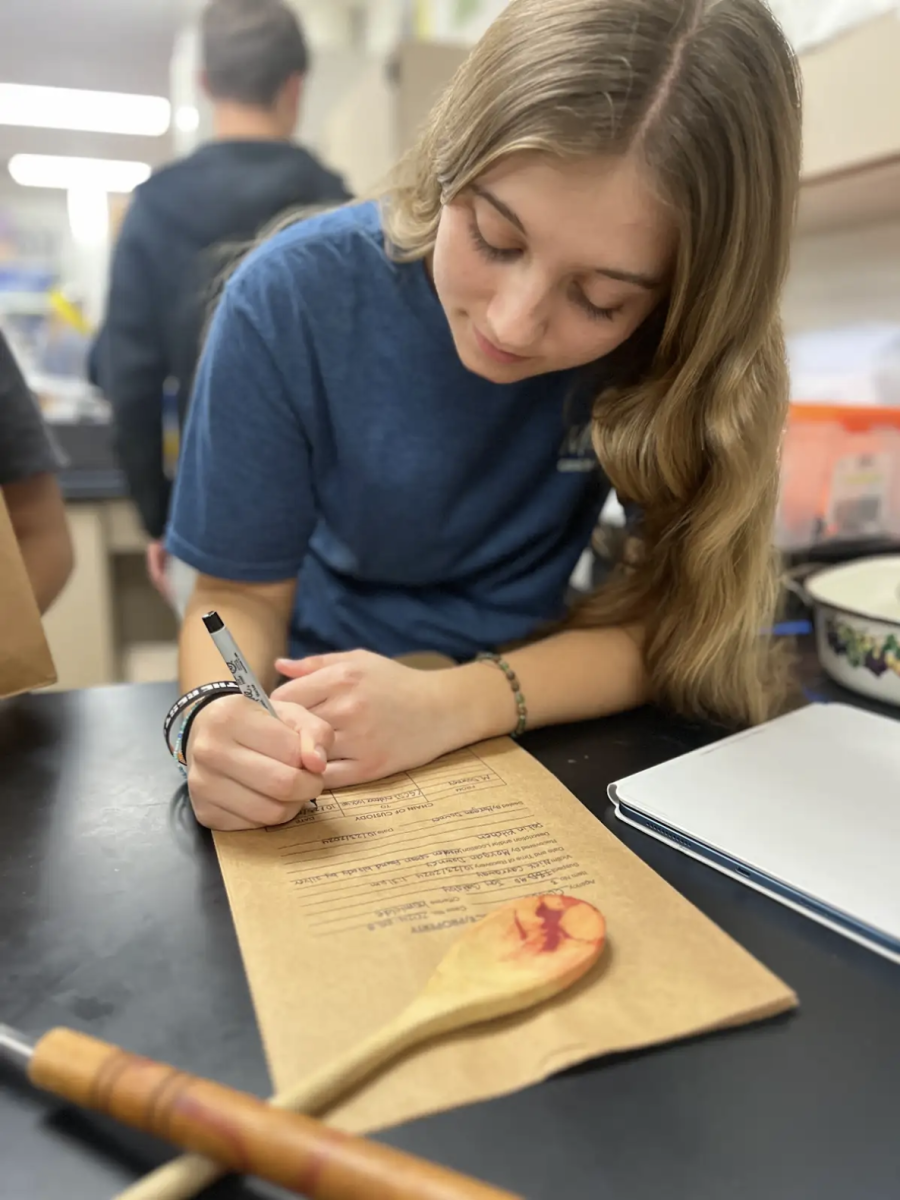 During Forensics class, junior Morgan Downey creates her evidence collection bag for her Crime Scene Evaluation Lab.  "We learned how to not contaminate the evidence that we collected from our assigned crime scene," said Downey. "It takes a lot of attention to detail, because if this were a real crime scene and we mess up then our evidence can't be used in court."